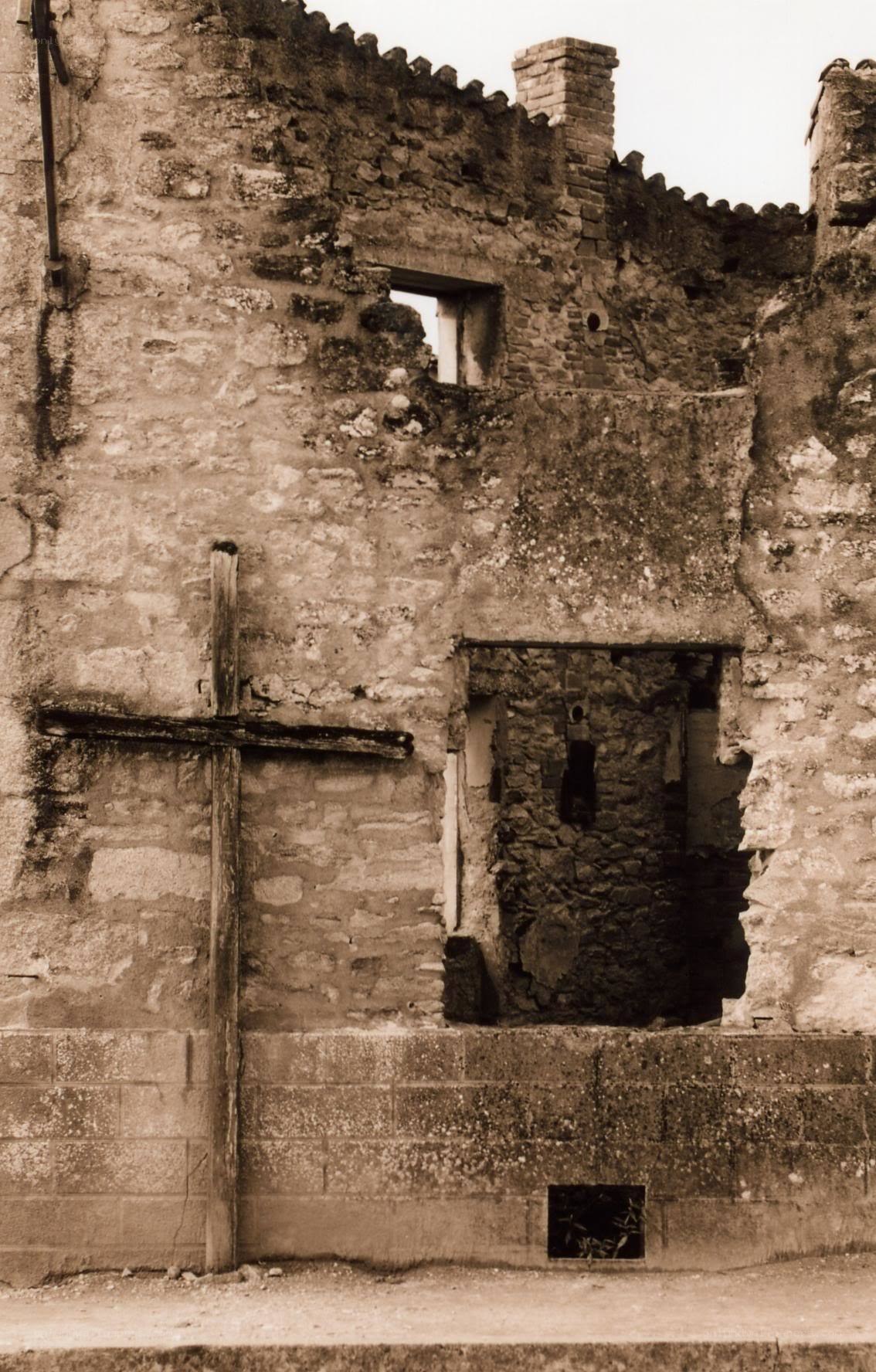 ruined stone building with cross