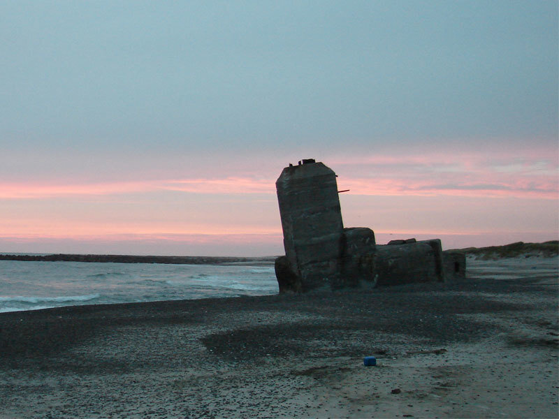 ruined structure on beach at dusk