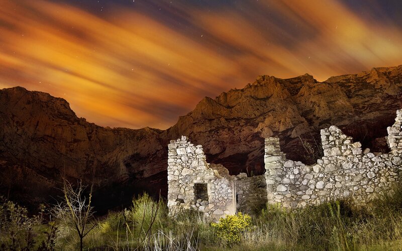 Ruins in Mountain Valley — Orange, Dramatic