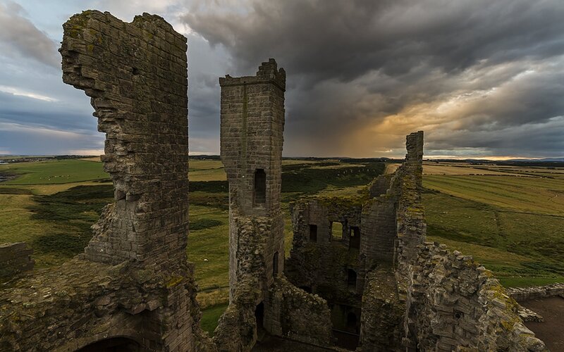 Ruins of a castle under stormy sky