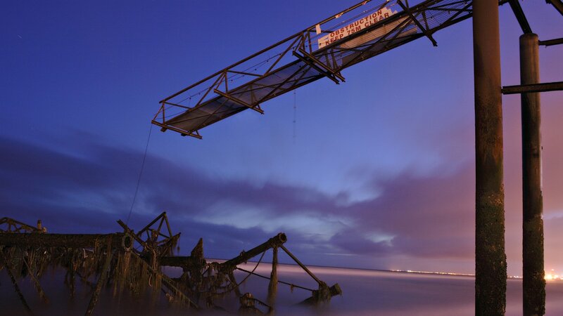 Ruins of a pier at dusk