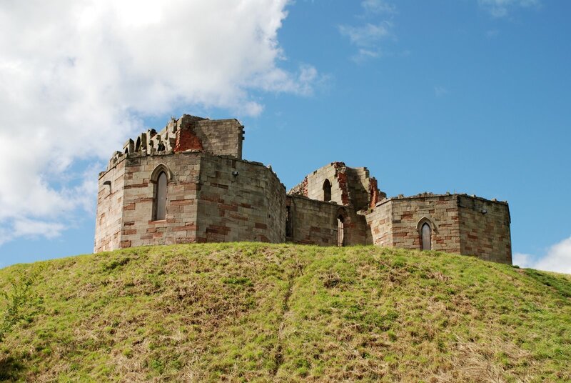 ruins on a grassy hill