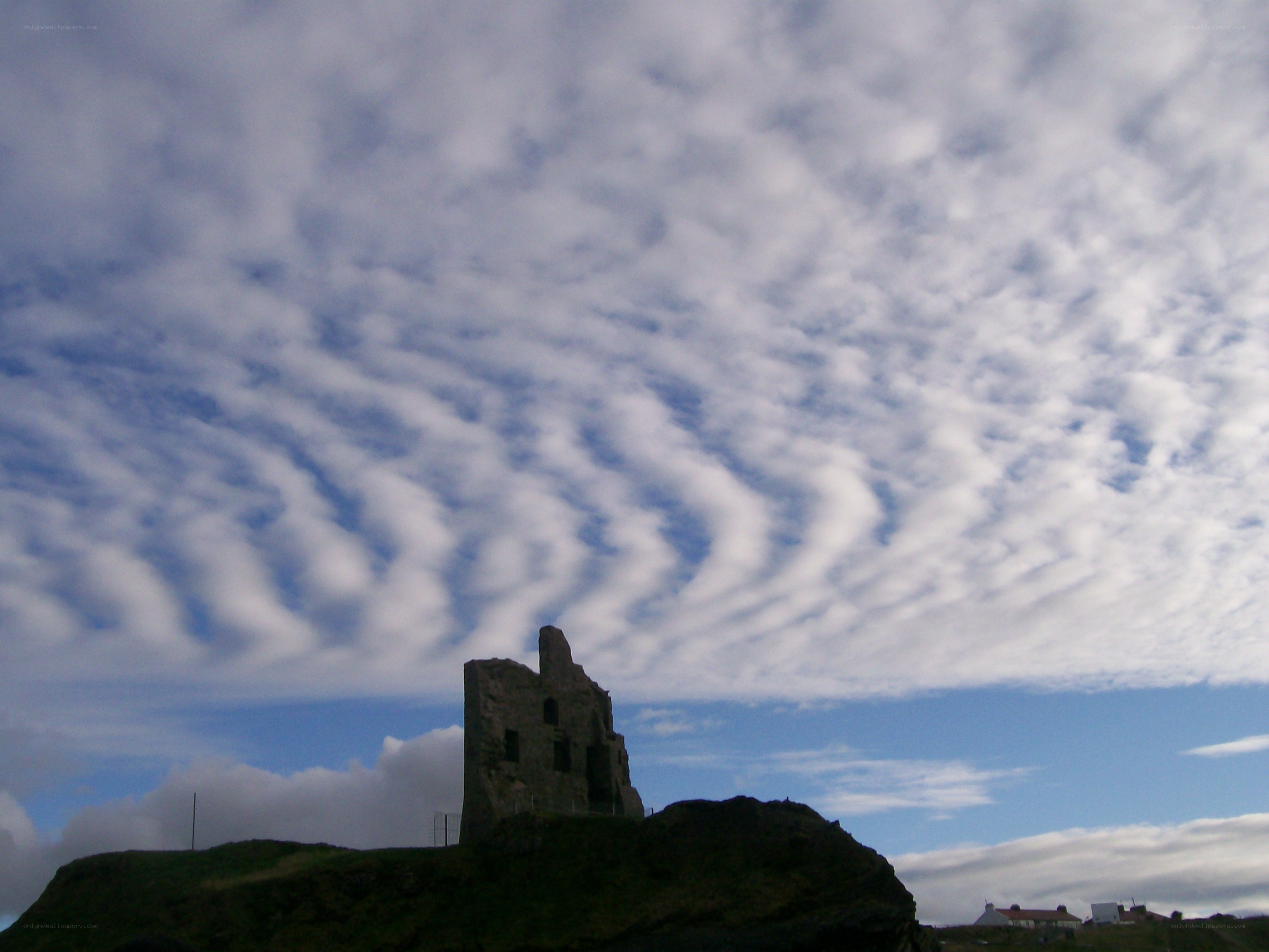 ruins on a hill under cloudy sky
