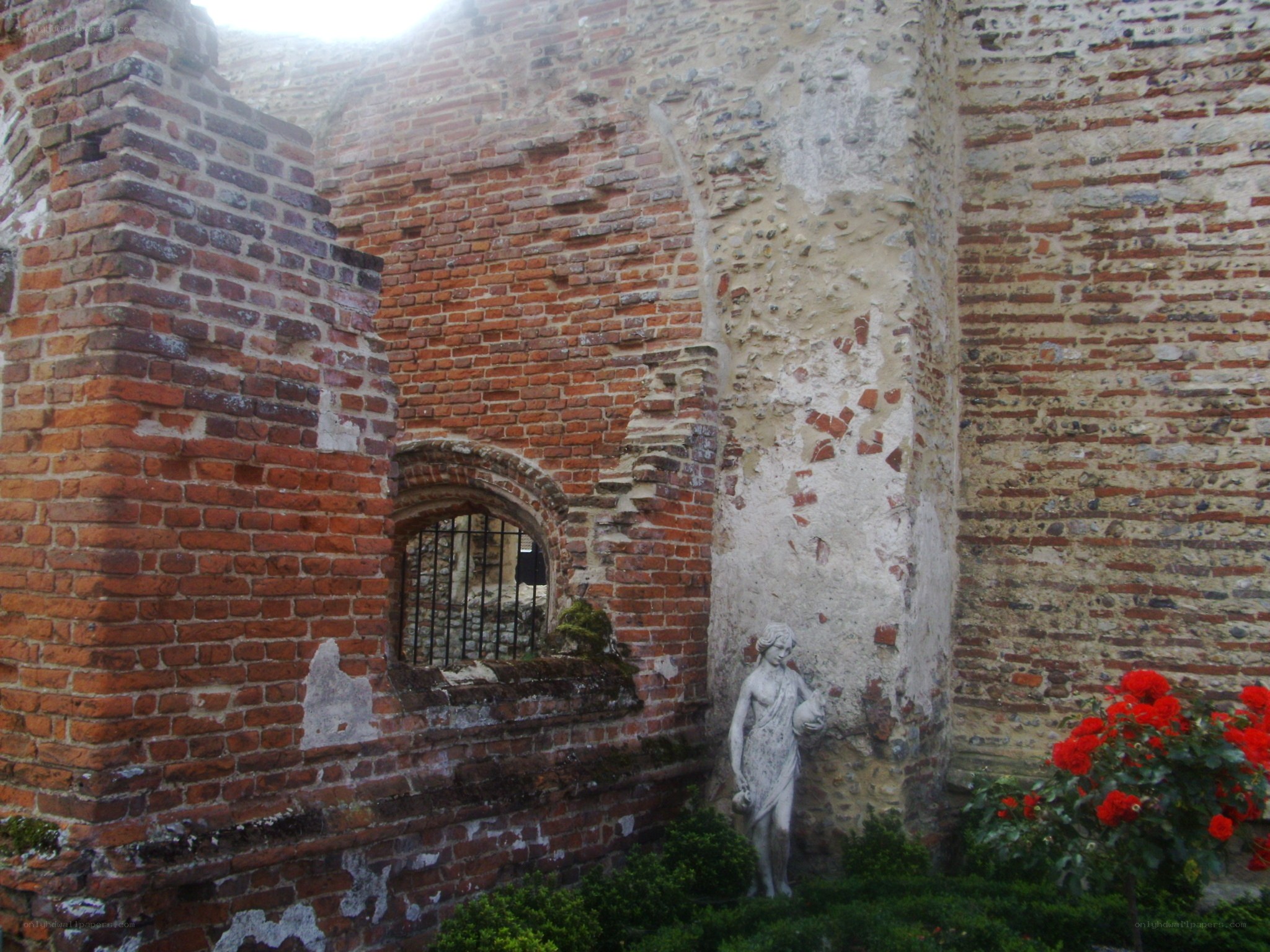 Ruins with statue and flowers