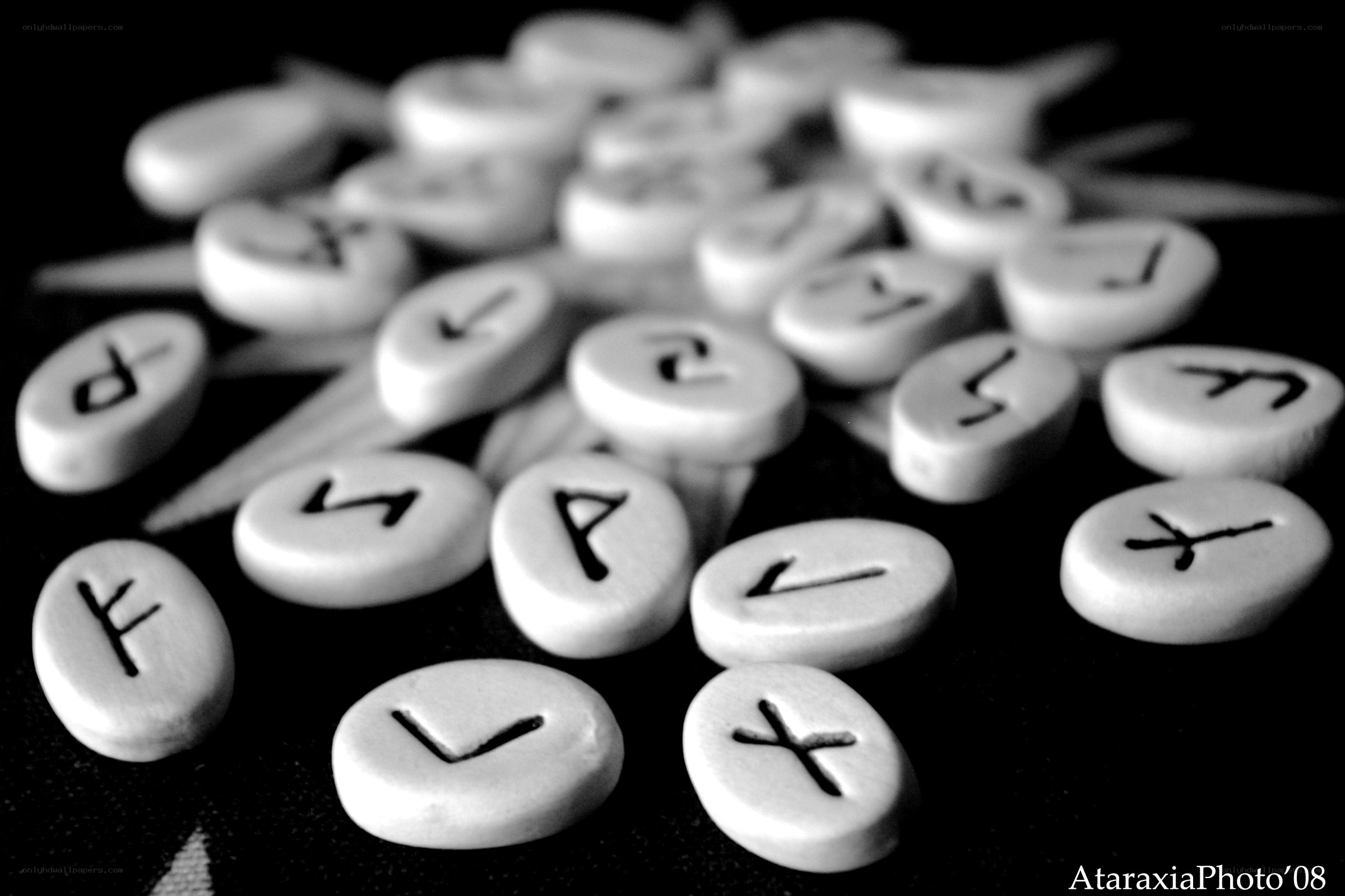Runic stones on black surface