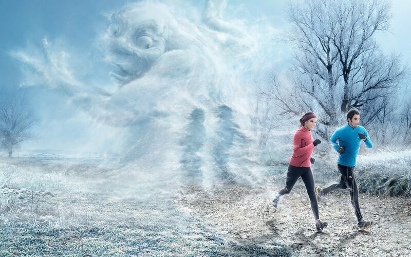 Runners in frosty landscape