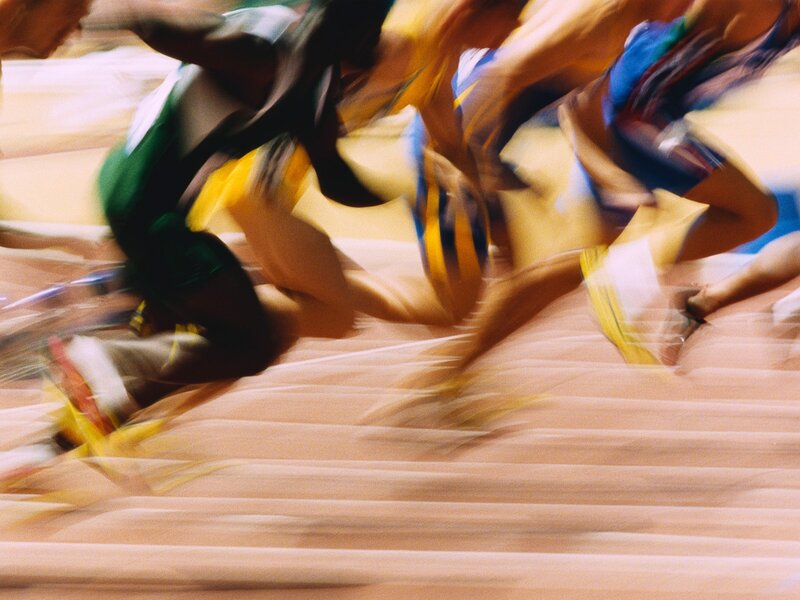 Runners in motion on track