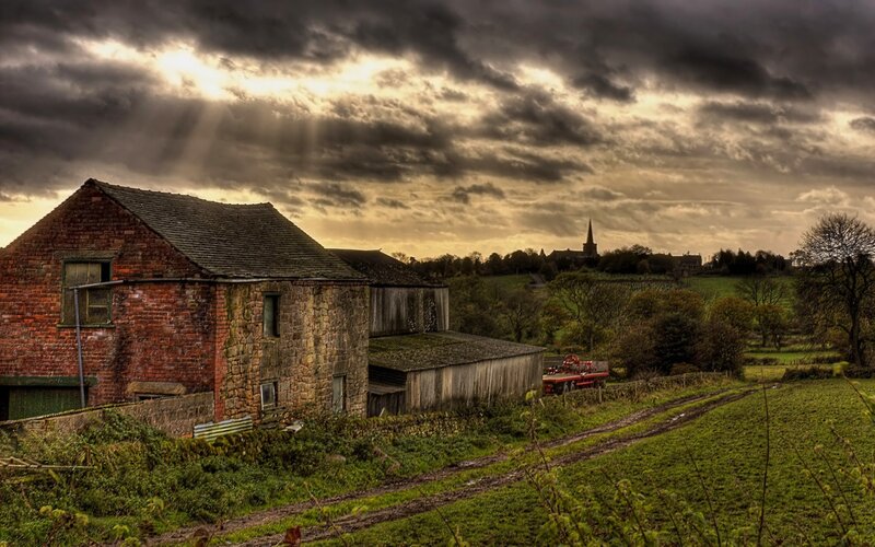 Rural farm under stormy sky