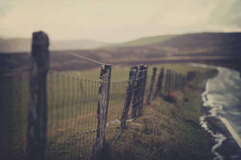 rural fence along a winding road