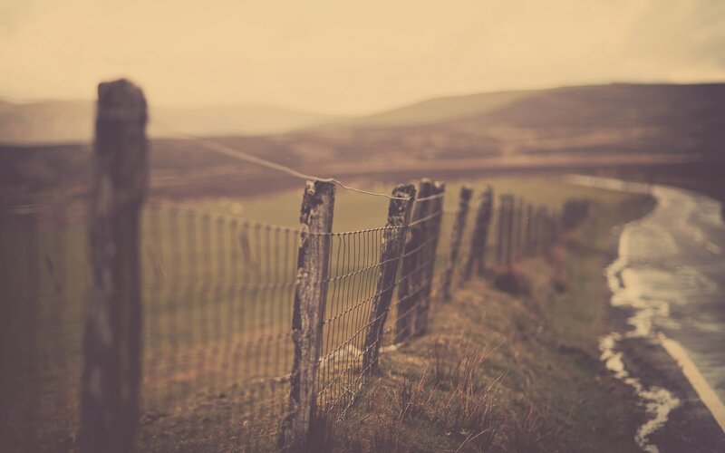 rural fence along a winding road