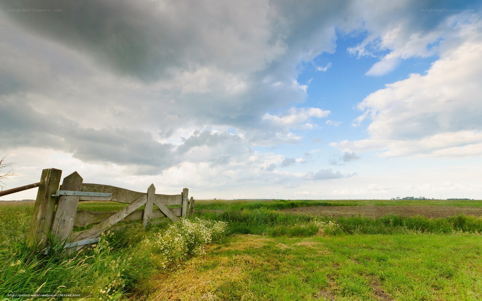 Rural fence under cloudy sky