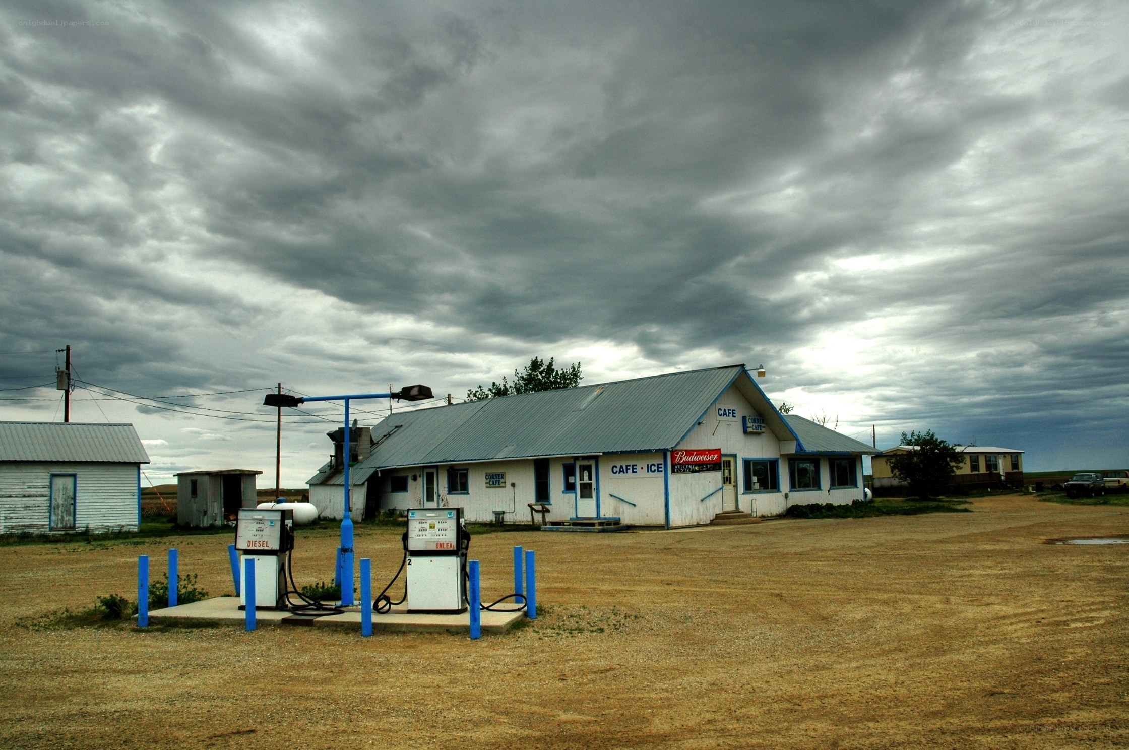 Rural gas station under stormy sky