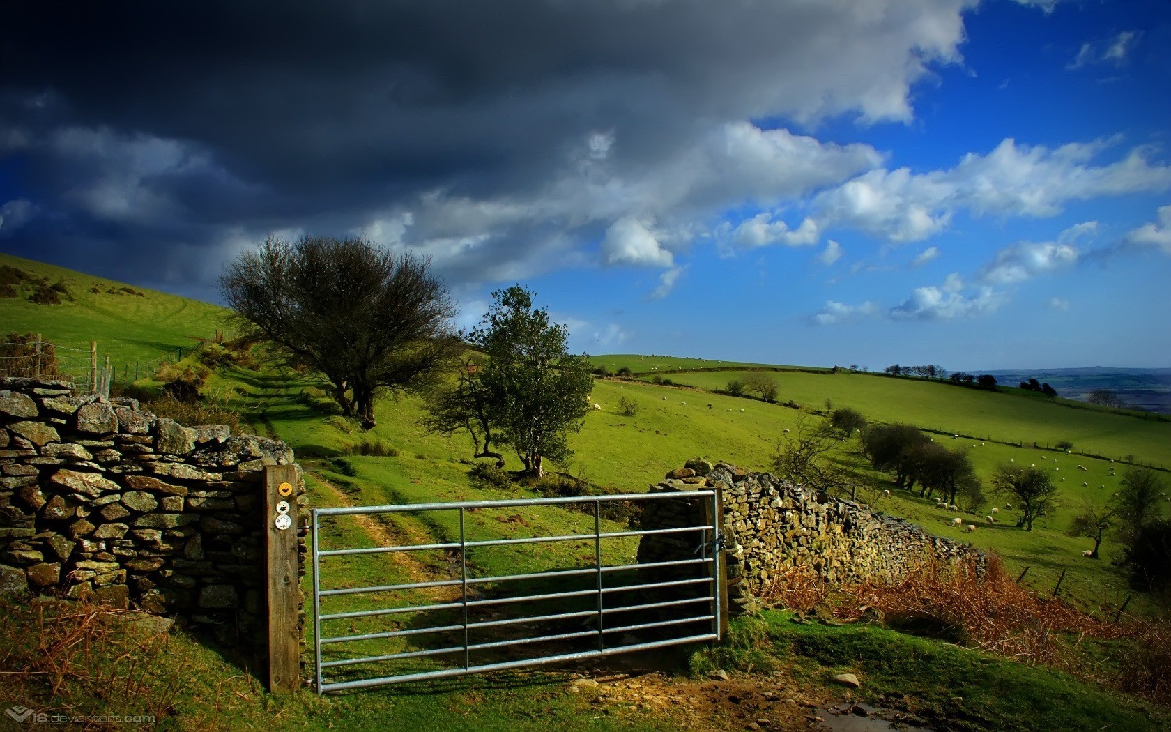 Rural gate under stormy sky