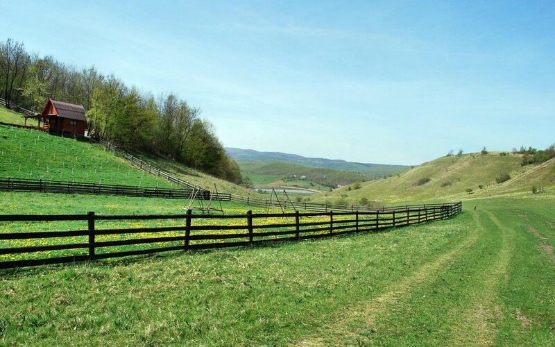 Rural landscape with cabin and fence