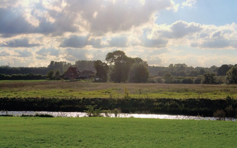 Rural landscape with river and house