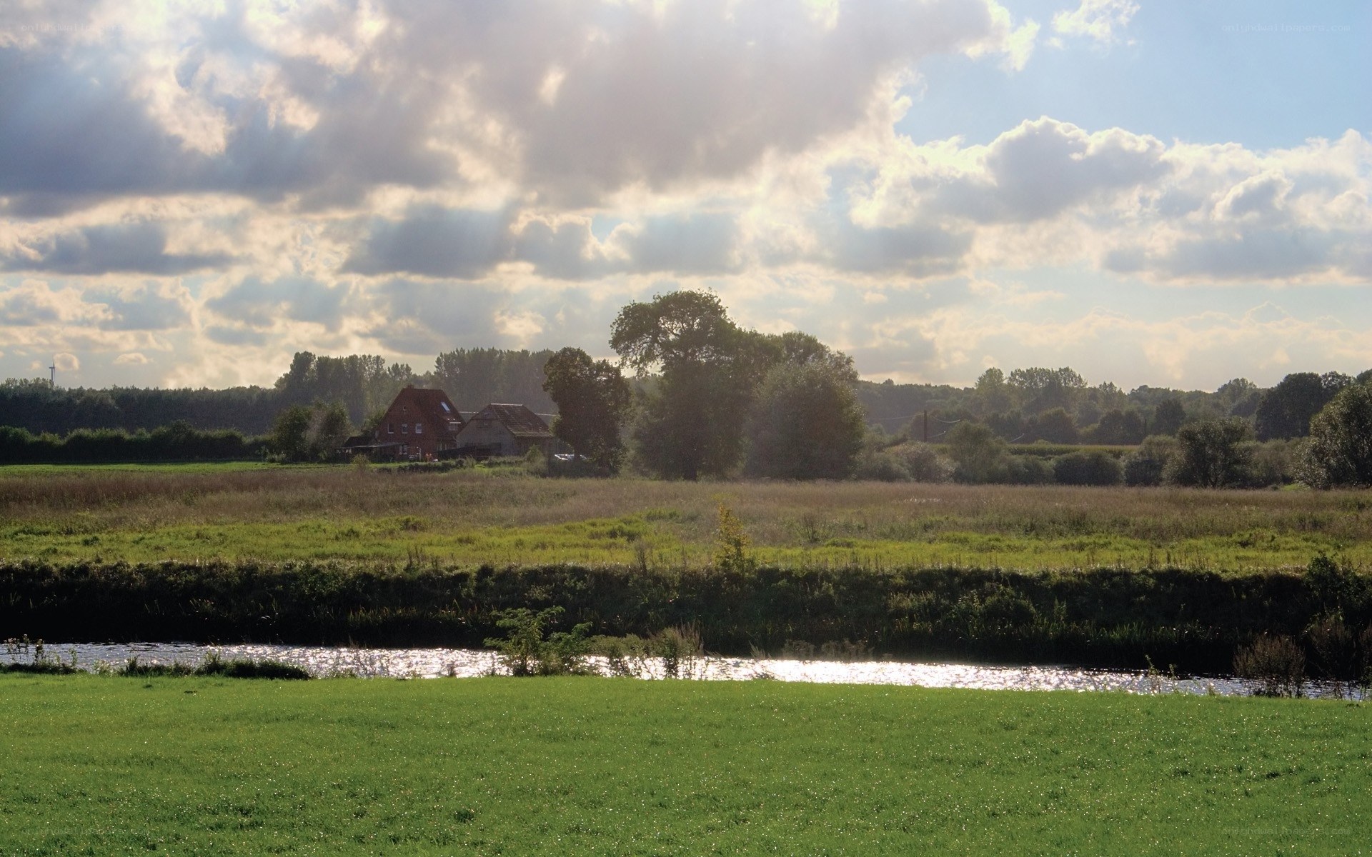 Rural landscape with river and house