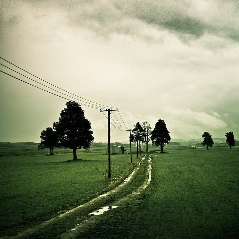 Rural path under cloudy sky