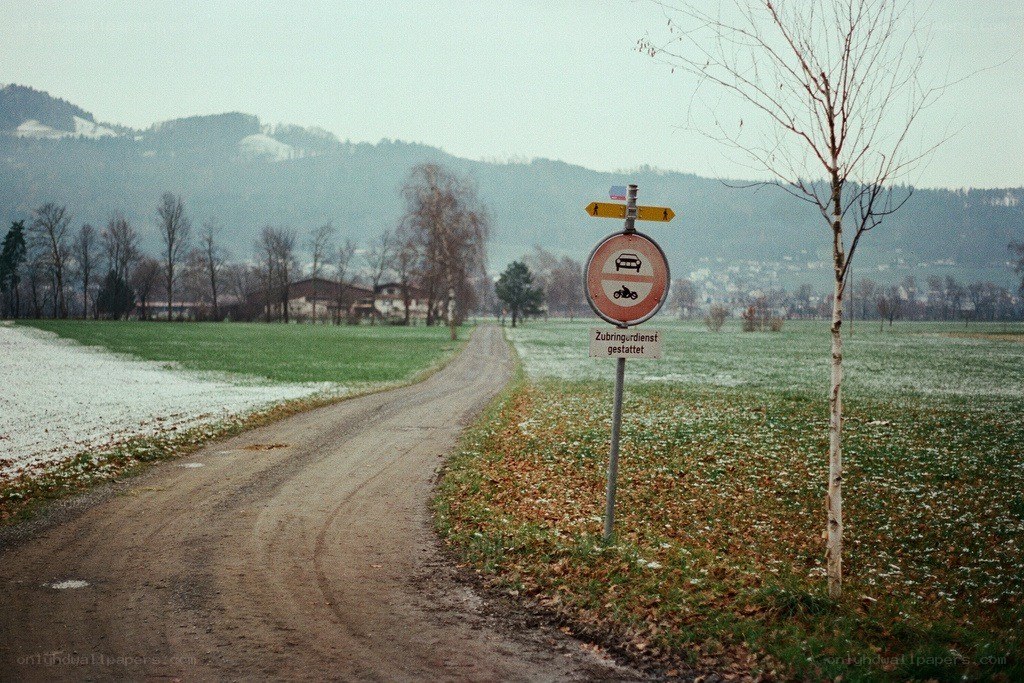 Rural road with snow and mountains
