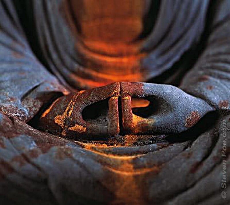 Rusted Buddha hand sculpture