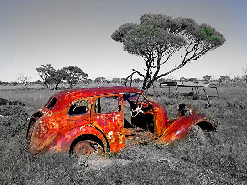 Rusted car in a field