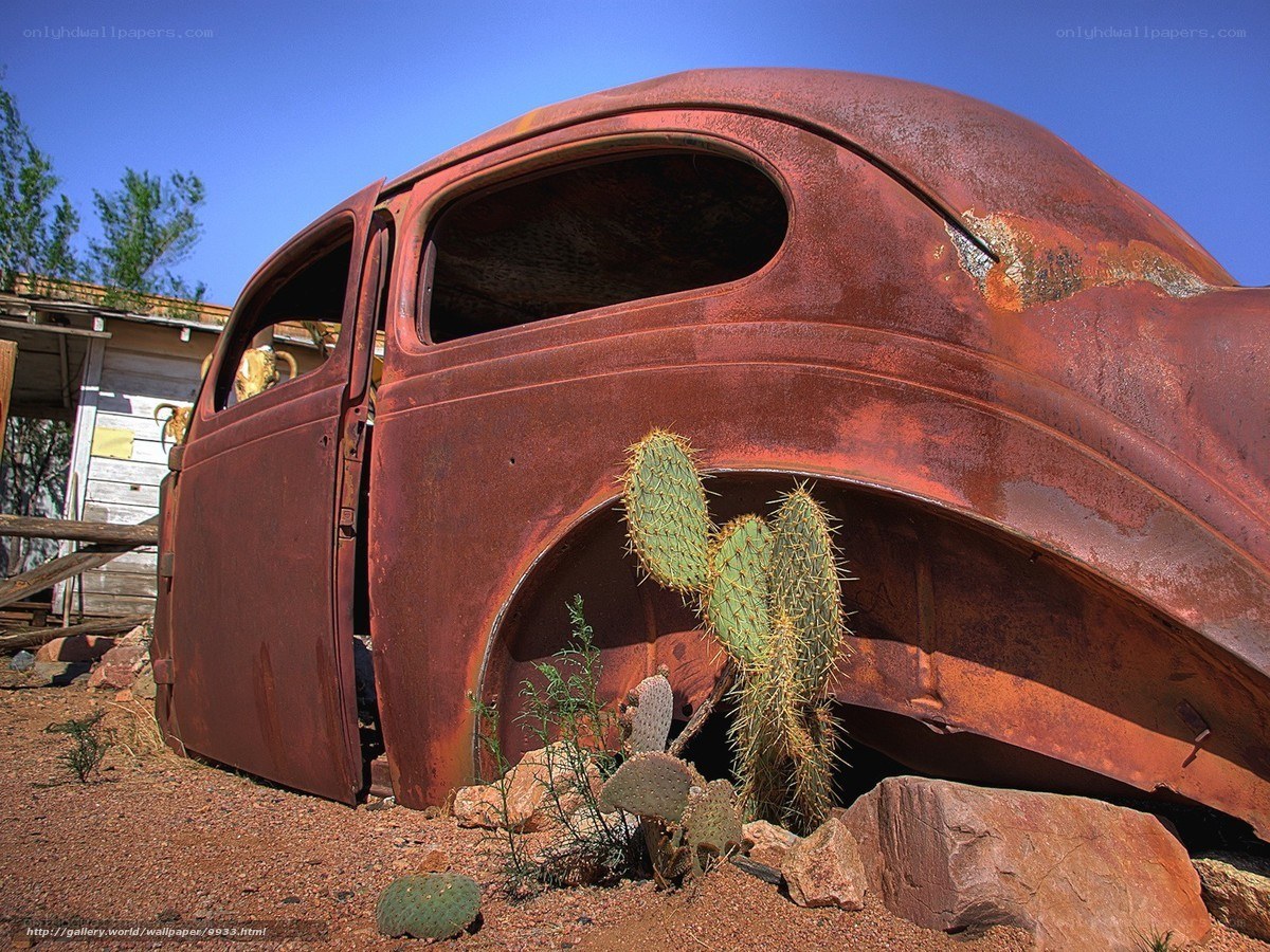 Rusted car in desert