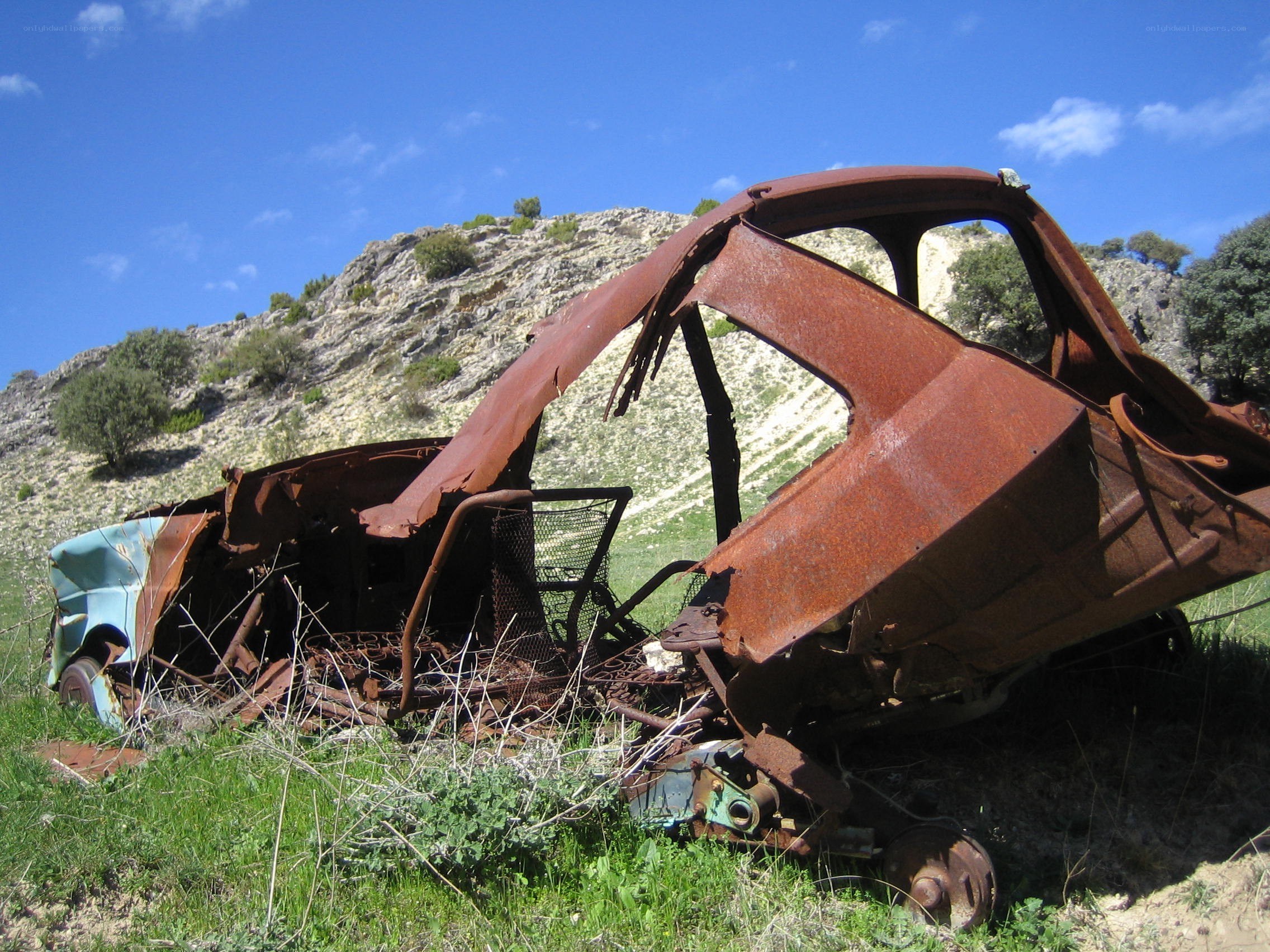 Rusted car wreck in a field