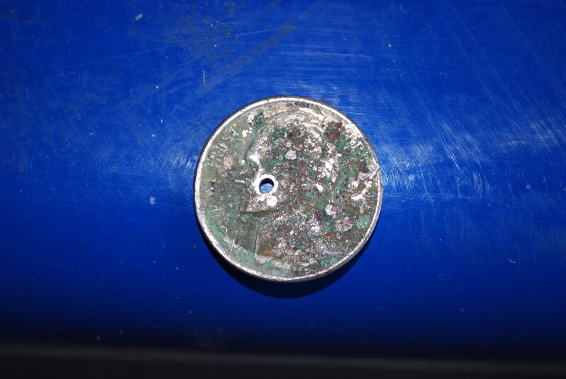 Rusted coin with hole