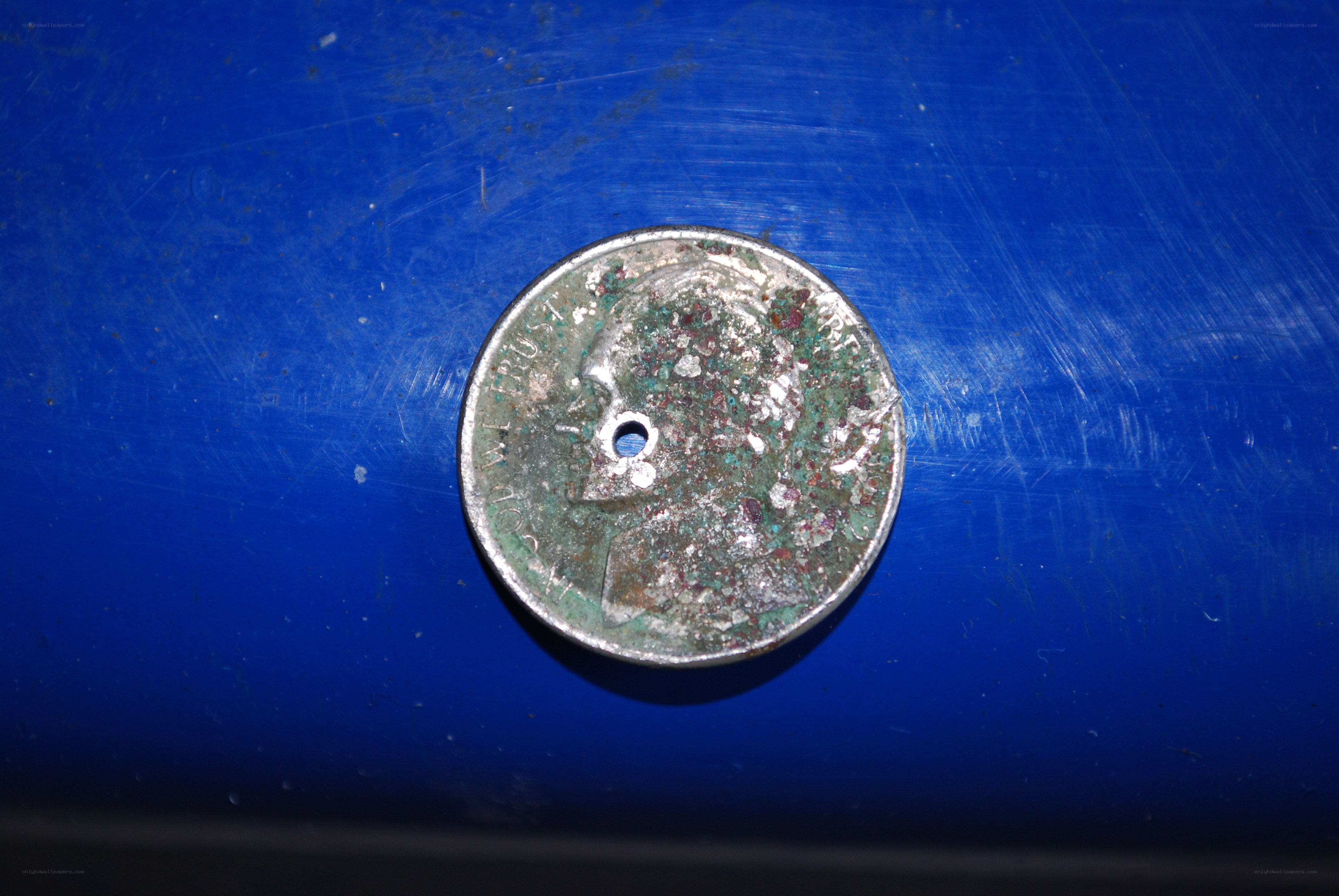 Rusted coin with hole