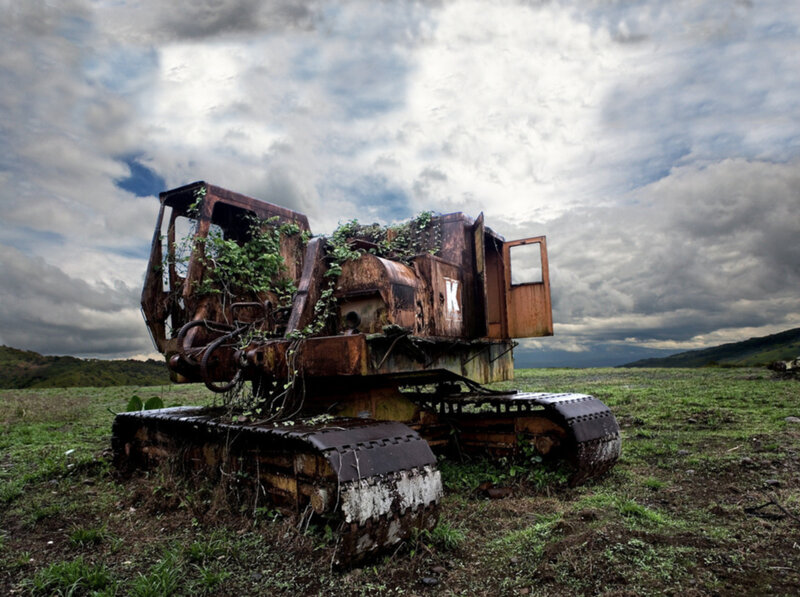 Rusted excavator in a field