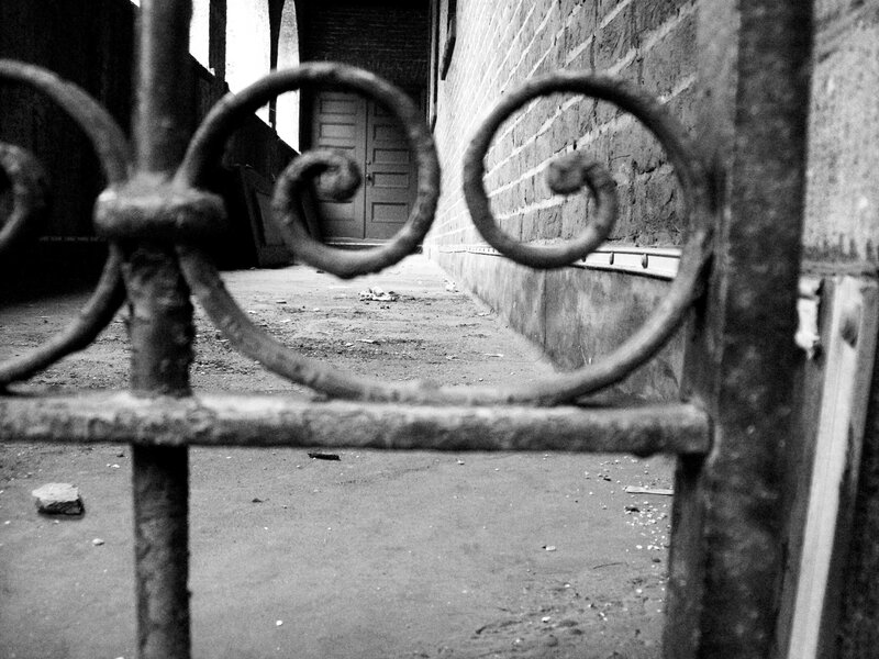 rusted gate in alleyway