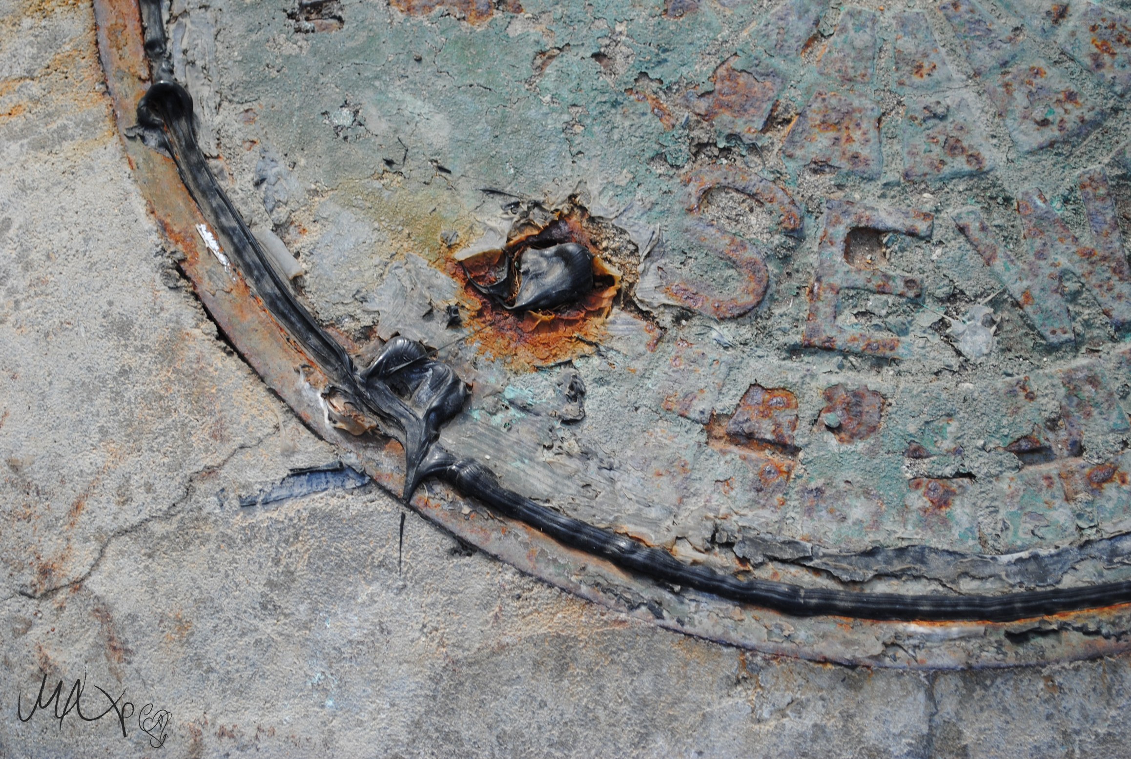 Rusted manhole cover with sealant