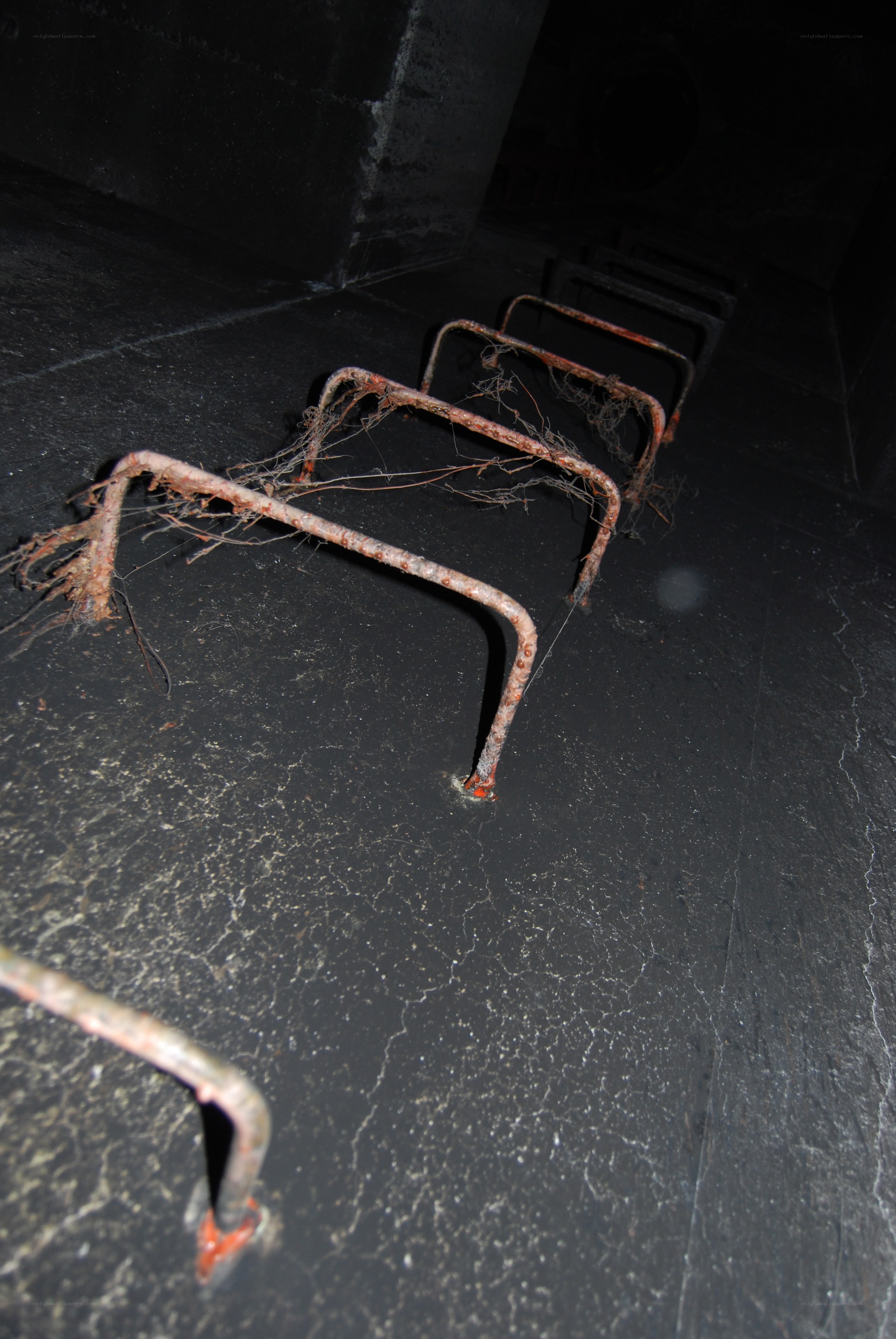 Rusted metal frames on dark floor