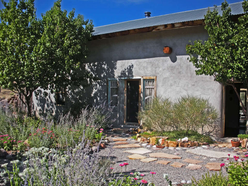 Rustic adobe home with garden