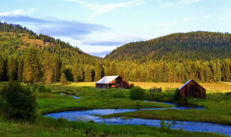 Rustic barns by a meandering stream