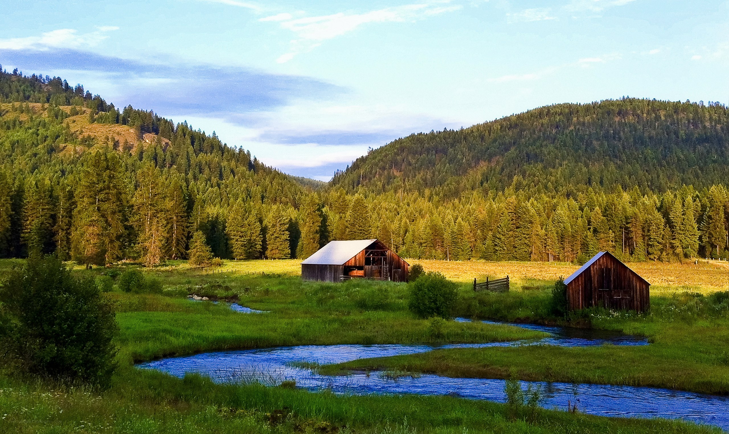 Rustic barns by a meandering stream