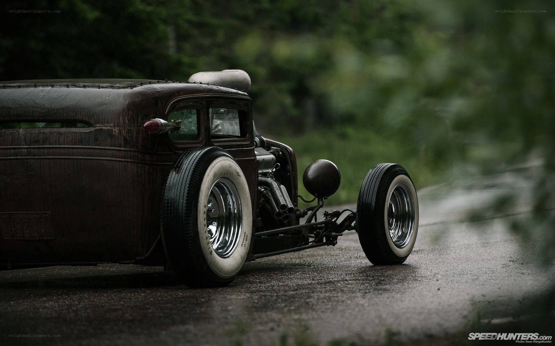 rustic hot rod on wet road