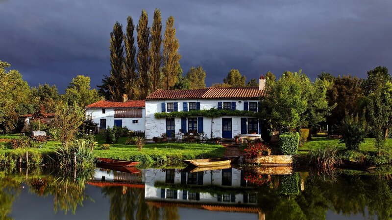 Rustic house by a pond