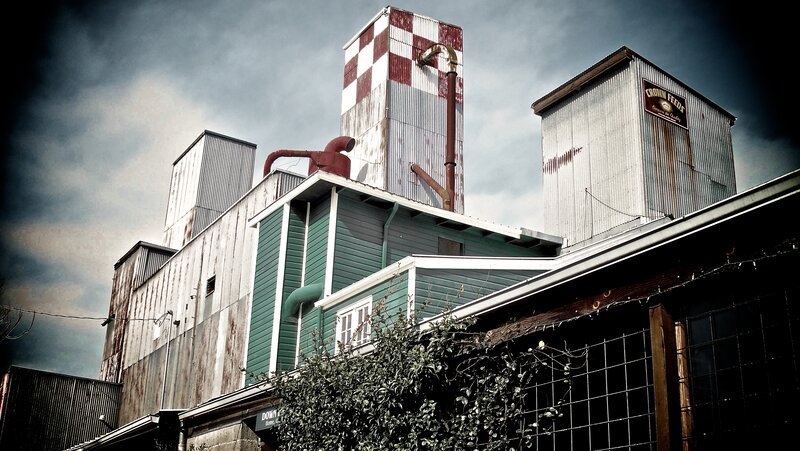 Rustic industrial buildings under cloudy sky