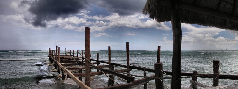 Rustic pier under stormy sky