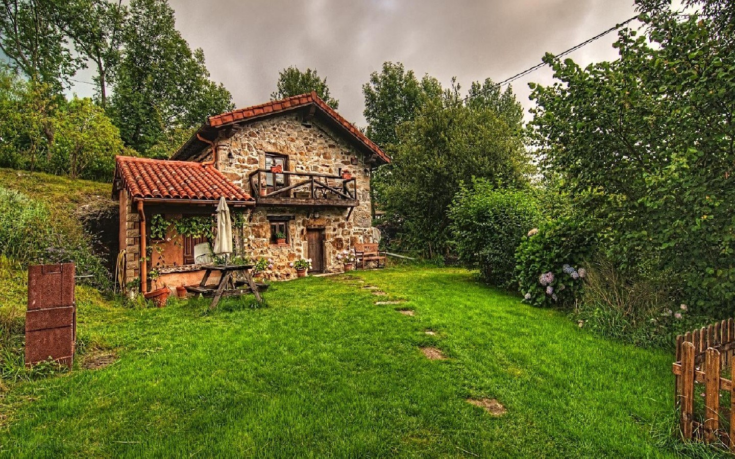 Rustic stone cottage in green garden