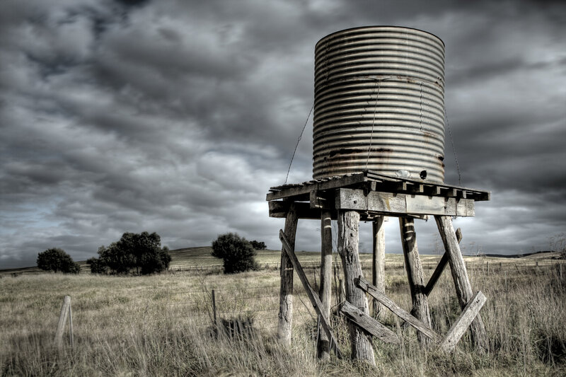 Rustic water tank in a field