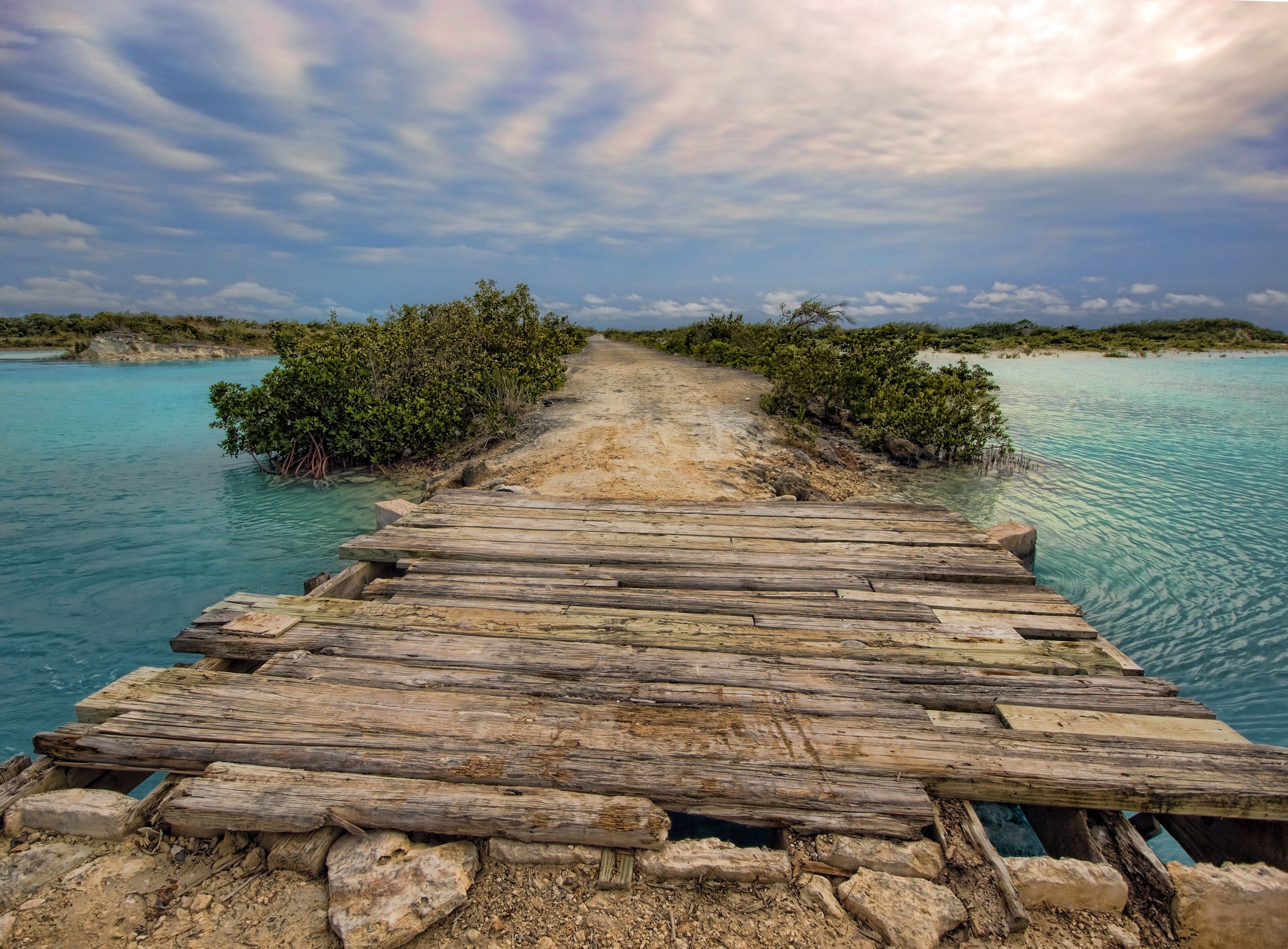 Rustic wooden bridge over turquoise water
