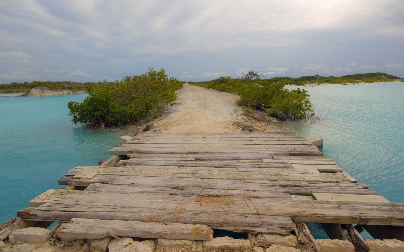 Rustic wooden bridge over turquoise water