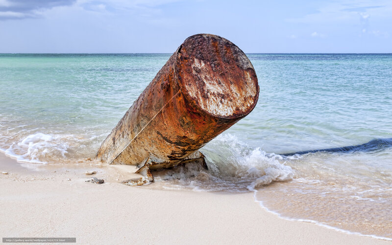 Rusty barrel on beach