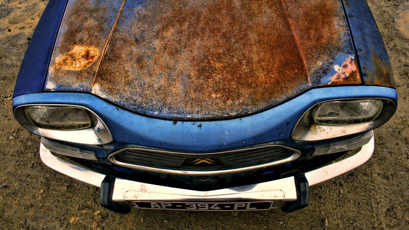 Rusty blue car front view