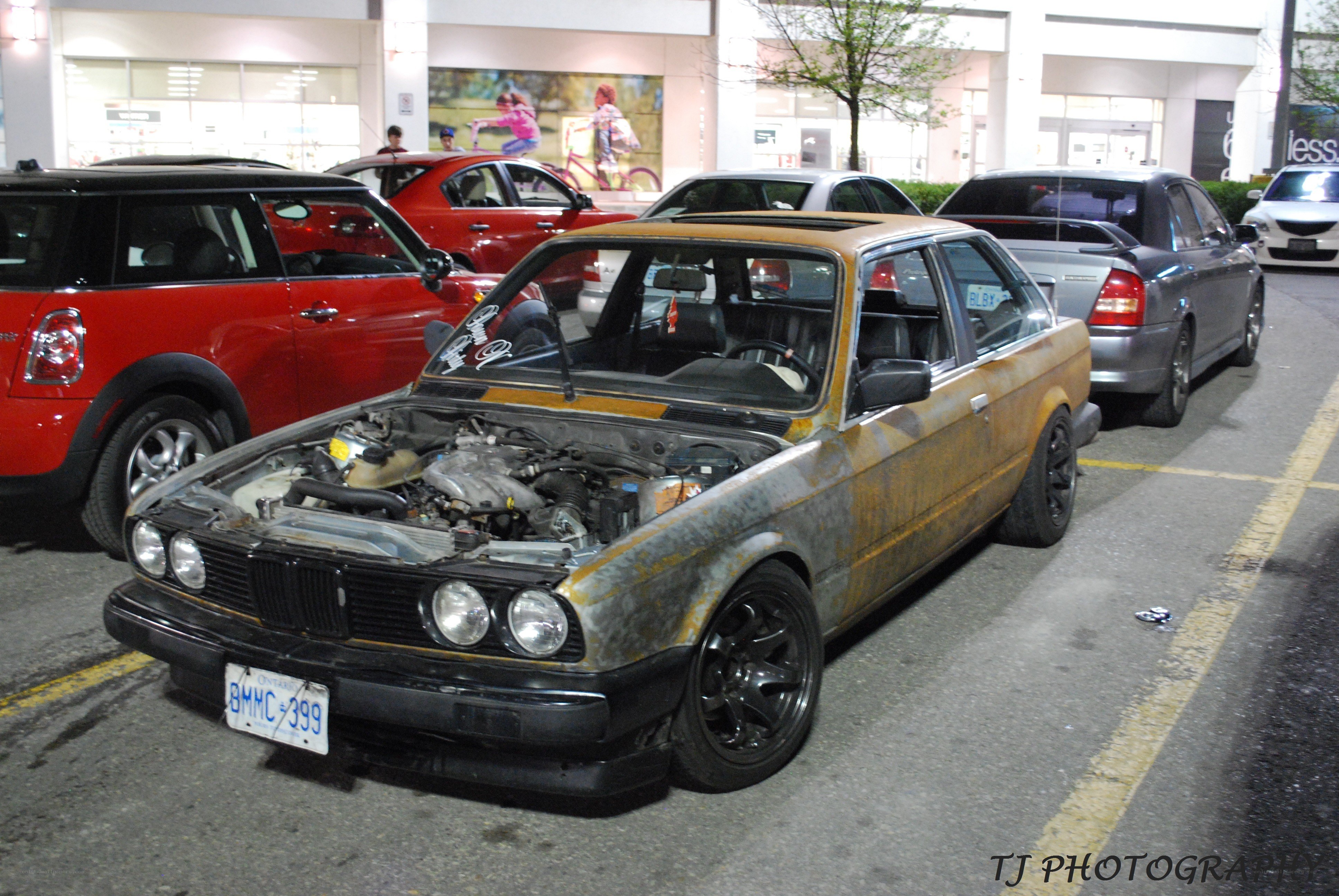 Rusty BMW in parking lot