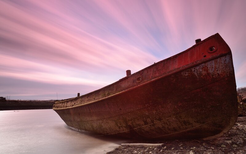 Rusty boat at sunset