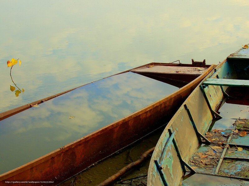 Rusty boats on calm water