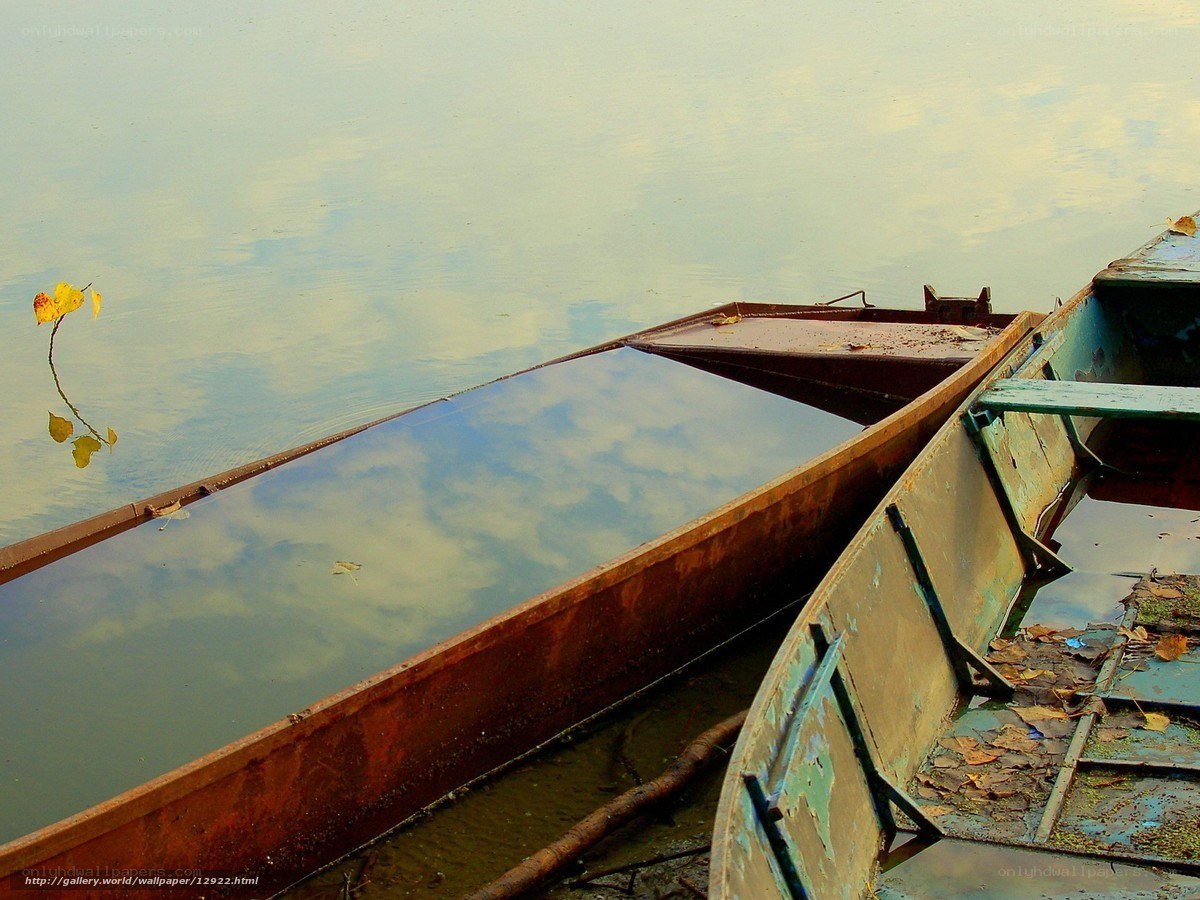 Rusty boats on calm water