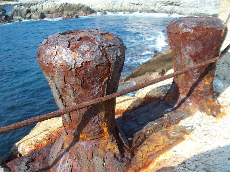 Rusty bollards by the sea